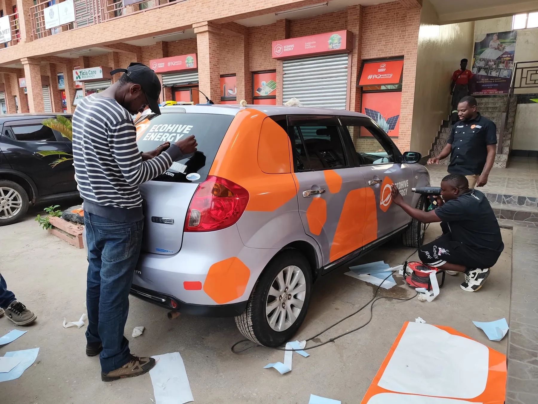Ulendo team fitting a vehicle wrap