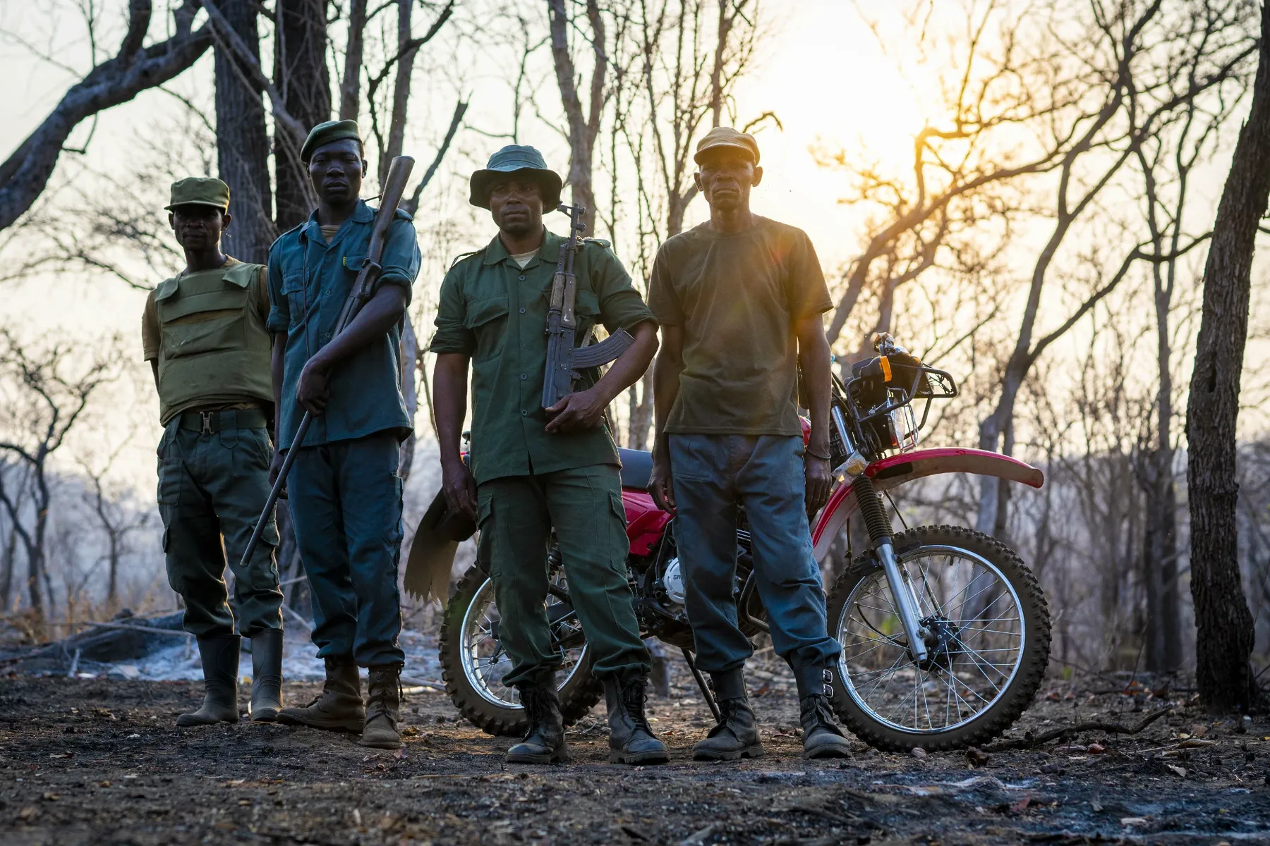 Wildlife rangers and crew with a motorbike in the bush